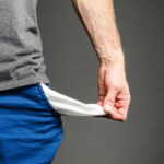 Person pulling out empty pocket from shorts