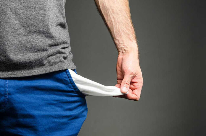 318205070 Person pulling out empty pocket from shorts