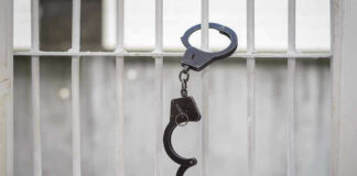 Handcuffs hanging on a barred window