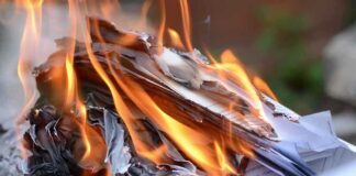 Burning papers with flames and smoke rising