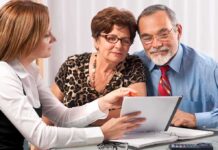 A financial advisor discussing documents with an elderly couple