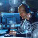 Man with headset working at computer holographic icons