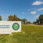 Federal Aviation Administration sign on grassy lawn