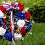 A patriotic memorial wreath adorned with red white and blue flowers