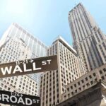 $211 Million Vanishes—Wall Street Shaken Street signs for Wall Street and Broad Street with skyscrapers in the background