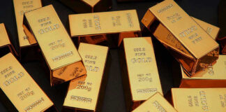 Gold bars stacked on dark background