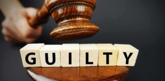 A gavel above wooden blocks spelling GUILTY