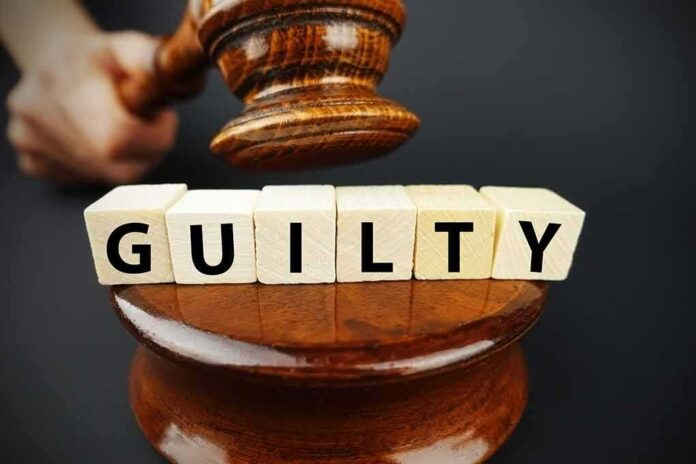 A gavel above wooden blocks spelling GUILTY