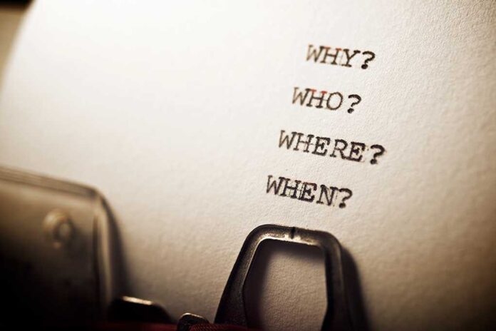 Close-up of a typewritten page with four questions: Why?, Who?, Where?, When?