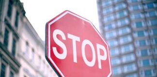 A red stop sign prominently displayed in an urban setting