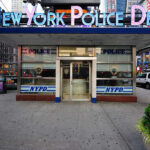 Mayor’s 12-Hour Silence Ignites NYPD Fury NYPD precinct building with signs on a city street