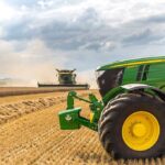 Trump’s $12 Billion Farmer Rescue Stuns Critics A green tractor in a wheat field.