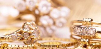 Close-up of various gold rings adorned with sparkling gems