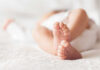 French Baby Bombshell—WHERE’S The PROOF? Close-up of baby feet lying on blanket.