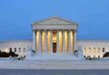 The U.S. Supreme Court building illuminated at night
