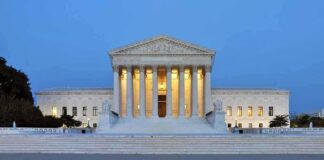 The U.S. Supreme Court building illuminated at night