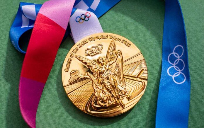 shutterstock_2004940706.jpg Gold Olympic medal from the Tokyo 2020 Games with a colorful ribbon