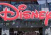 Disney CROWNS New Boss–What This Means For The Park Bright red Disney logo displayed on a storefront window