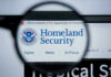 New DHS Boss–New AGENDA? Magnifying glass showing Homeland Security website.