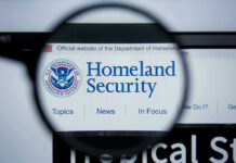 New DHS Boss–New AGENDA? Magnifying glass showing Homeland Security website.
