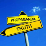 Yellow signs: Propaganda left, Truth right. Blue sky background.