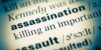 Close-up of a dictionary page showing the definition of 'assassination'