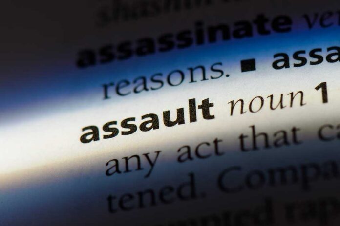 Close-up of a dictionary page showing the definition of the word 'assault'