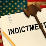 A legal document labeled INDICTMENT with a gavel and pencil