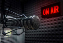 Radio microphone in studio with On Air sign.