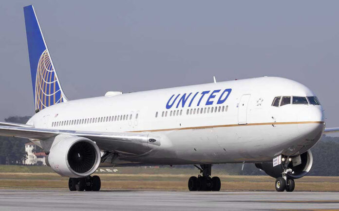 623296490 United Airlines plane on the runway.