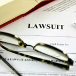 Vile TikTok Backfires — Job Gone Lawsuit paperwork with glasses, pen, and an open book.