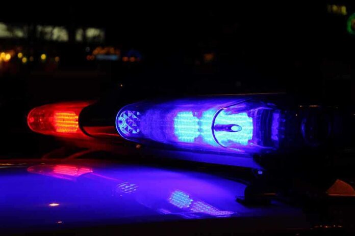 Close-up of police lights flashing in blue and red at night