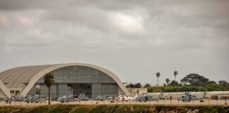 airport hangar with helicopters near a shoreline