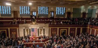 A crowded congressional chamber with members in discussion