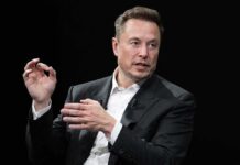 man in a suit speaking with hand gestures
