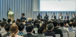 Audience listening to a panel discussion in a conference hall