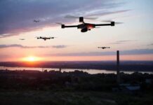 Drones flying over a river landscape at sunset