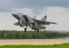 Military jet taking off from runway
