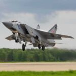 Military jet taking off from runway