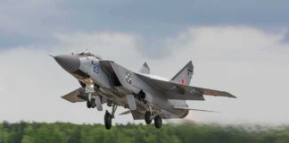 Military jet taking off from runway