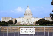 View of the U.S. Capitol building with a security barrier in front
