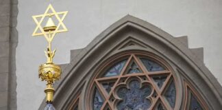 Star of David atop synagogue roof with stained glass window