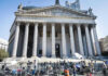 Reporters and photographers gathered outside a neoclassical courthouse