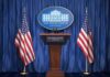 Power Grab: One Official, Two Key Roles White House press podium with microphones and two American flags