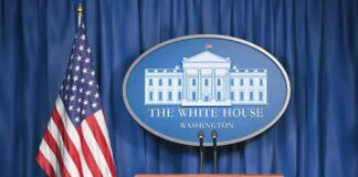 White House press briefing podium and US flag