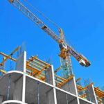 Tower crane over concrete building under construction