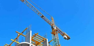 Tower crane over concrete building under construction