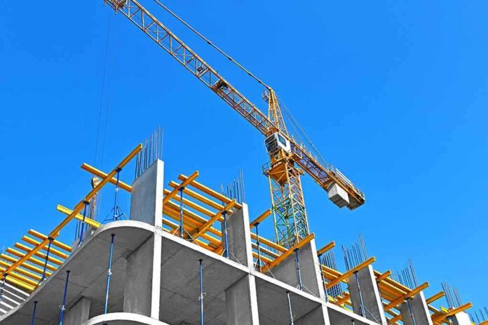 Tower crane over concrete building under construction