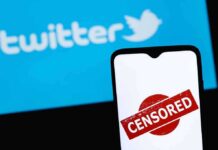 smartphone with censored stamp in front of blue social media logo