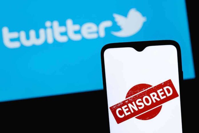 smartphone with censored stamp in front of blue social media logo